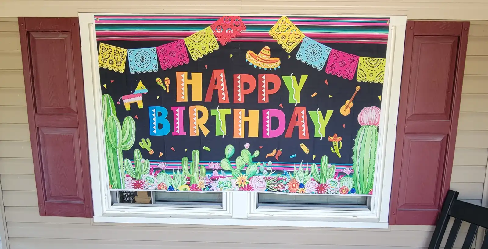 A festive Happy Birthday banner with pinatas, maracas, sombrero, guitar, and cacti.